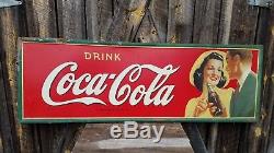 1942 Coca Cola Horizontal Sign with man and woman. 54inx18in. Painted metal