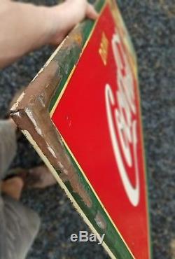1942 Coca Cola Horizontal Sign with man and woman. 54inx18in. Painted metal