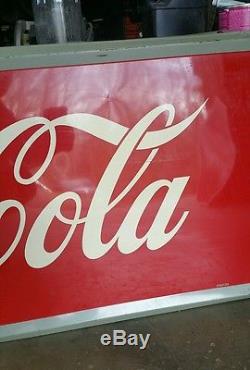 1950's Coca Cola Sign with Bottle. 59inx24in. Embossed frame. Painted metal