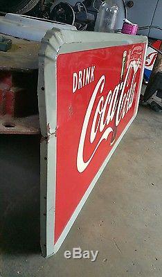 1950's Coca Cola Sign with Bottle. 59inx24in. Embossed frame. Painted metal